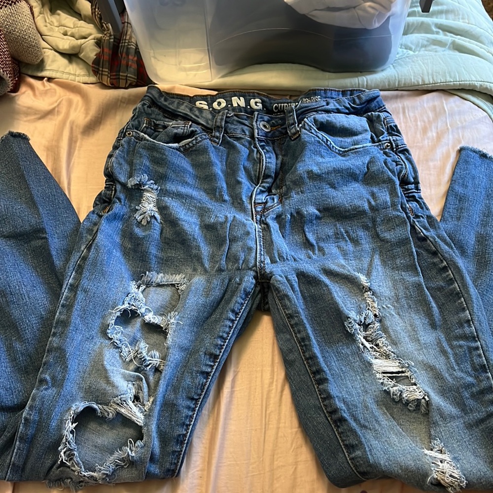 Destressed denim jeans